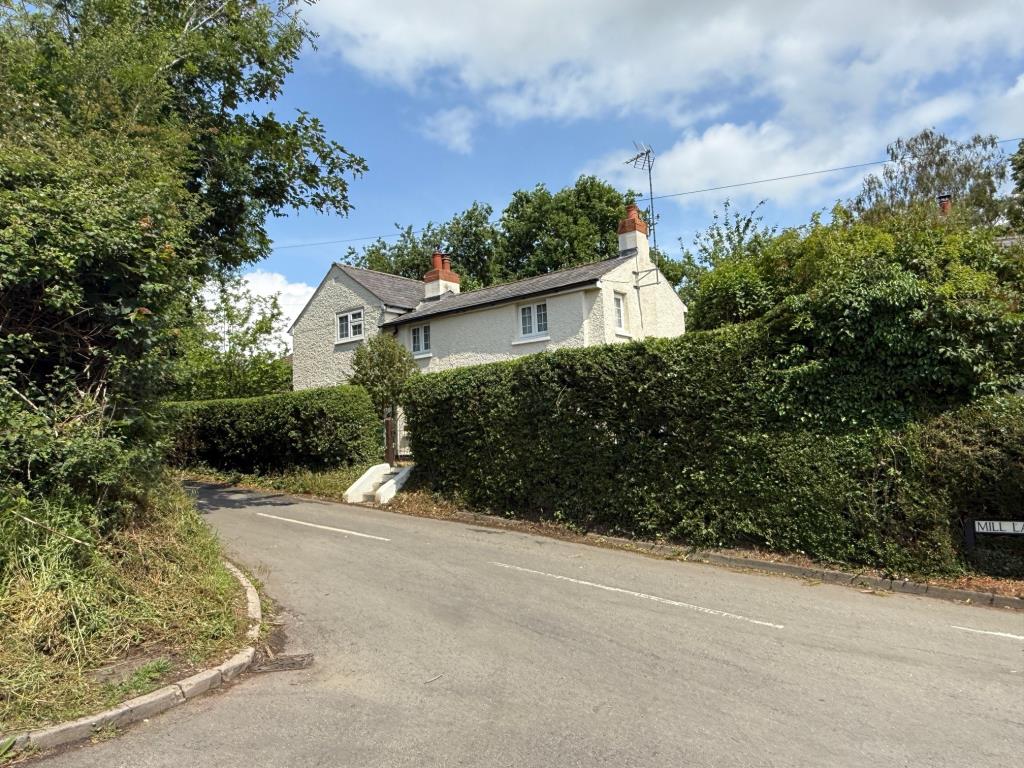 Lot: 150 - PERIOD COTTAGE FOR IMPROVEMENT - External photo showing the dwelling from roadside